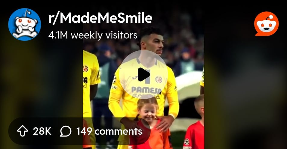 Footballer (Georges Mikautadze) protecting the ears of the mascot girl who seems to be disturbed by the loud stadium sounds